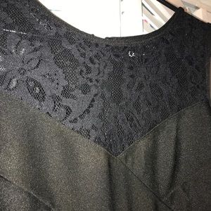 Black, tight dress with lace above the chest